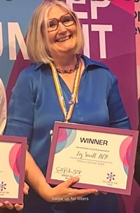 Liz Sewell with Fellow of the Year Cert